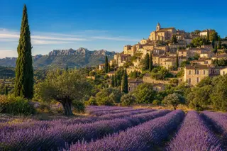 Vibrant Provençal countryside with lavender fields, stone village on a hillside, olive and cypress trees under golden sunlight.